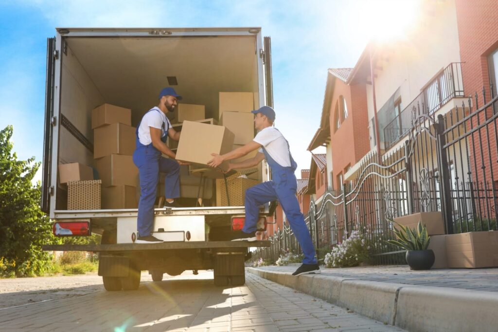"Professional movers loading a moving truck for a long-distance journey.