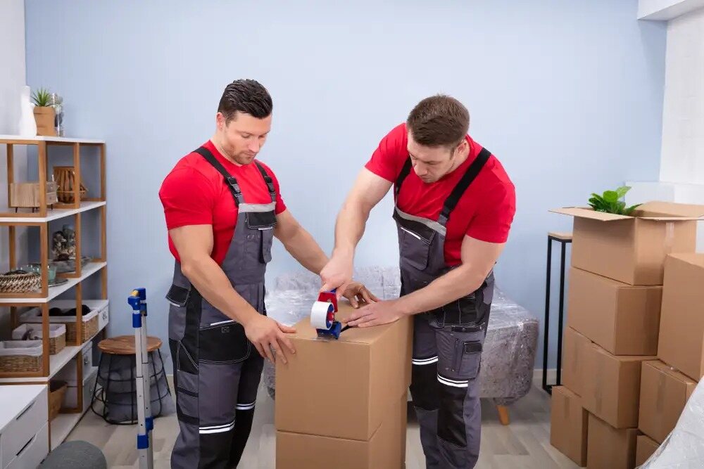 Expert team of movers carefully packing and organizing boxes for a stress-free office move.