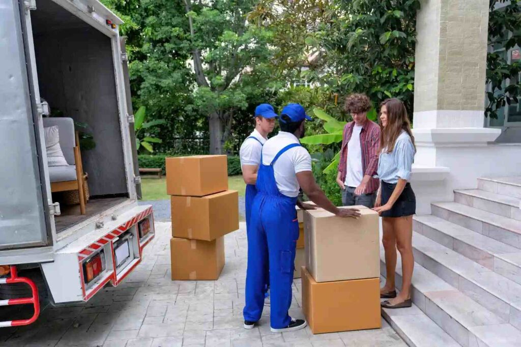 Professional movers loading furniture into an interstate moving truck.